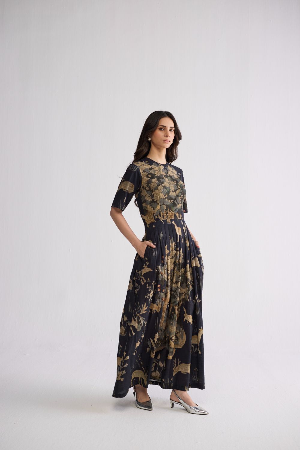 half pleated dress Avril gown, A box pleated dress features a type of pleating where fabric is folded into square-shaped pleats, giving the dress a structured and voluminous look. , A half-shoulder gown, also known as