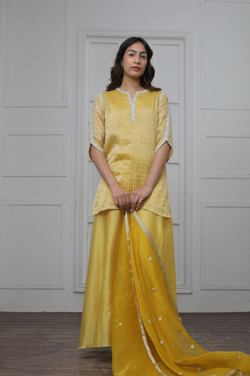 Banarsi Zari Stripe Kathiawadi Embroidered V yoke Kurta with Solid pants and Butti dupatta Kurta Sets by Myoho in yellow color for women Worldwide