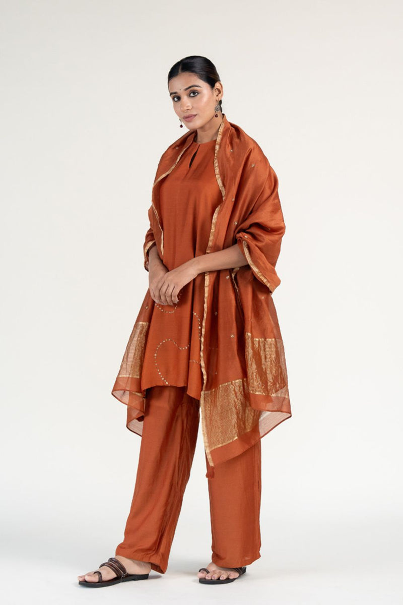 Mehr Kurta Set 
with Ayra Odhani-Rust silk by Nirjara in rust color for women Worldwide