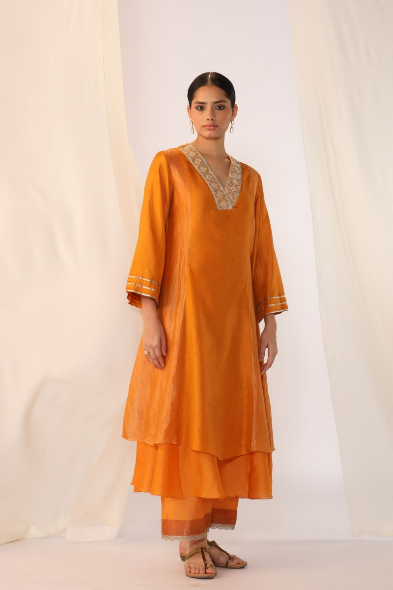 Double-layer kurta with handwork on neckline paired with pants silk by Myoho in orange color for women Worldwide