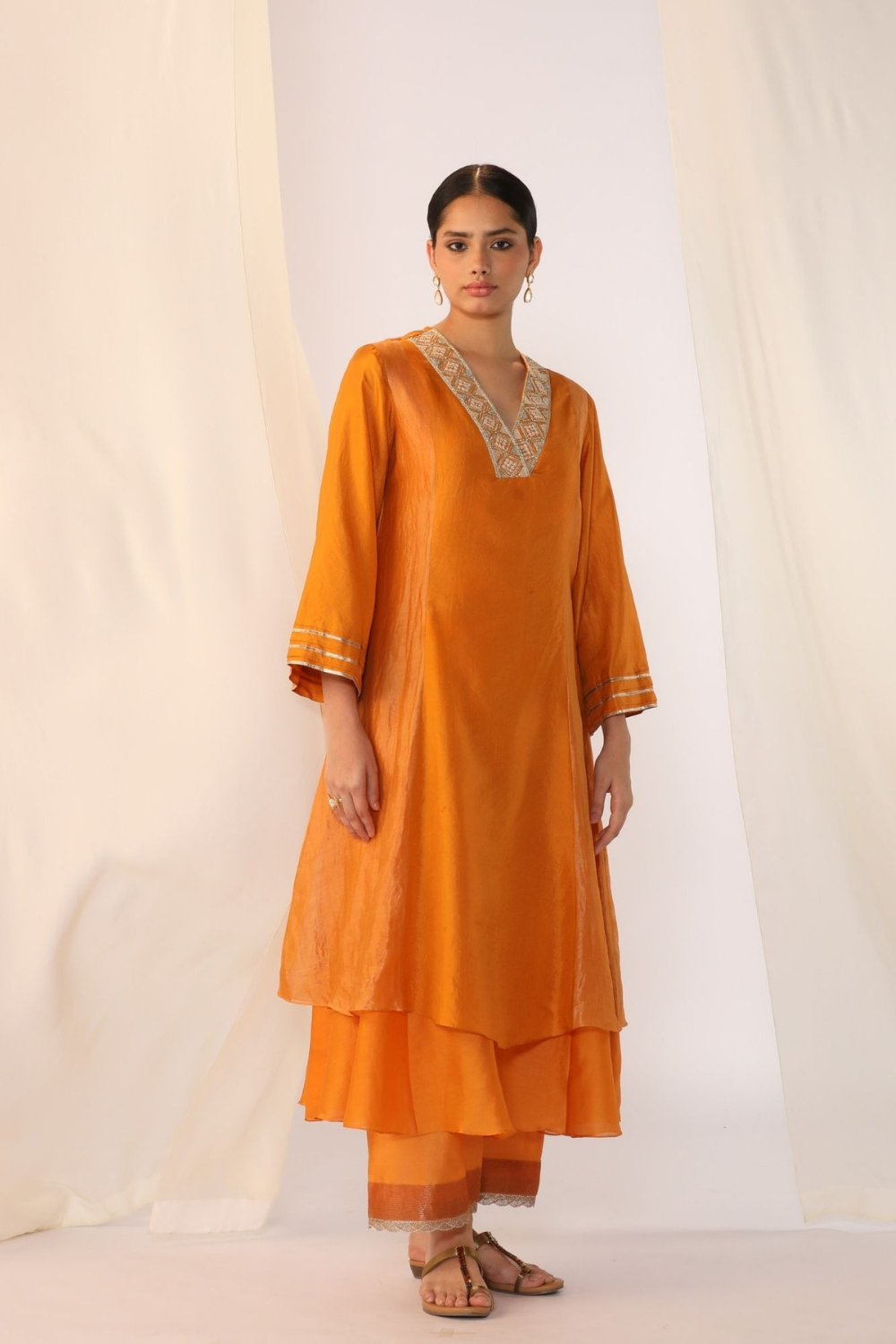 Double-layer kurta with handwork on neckline paired with pants