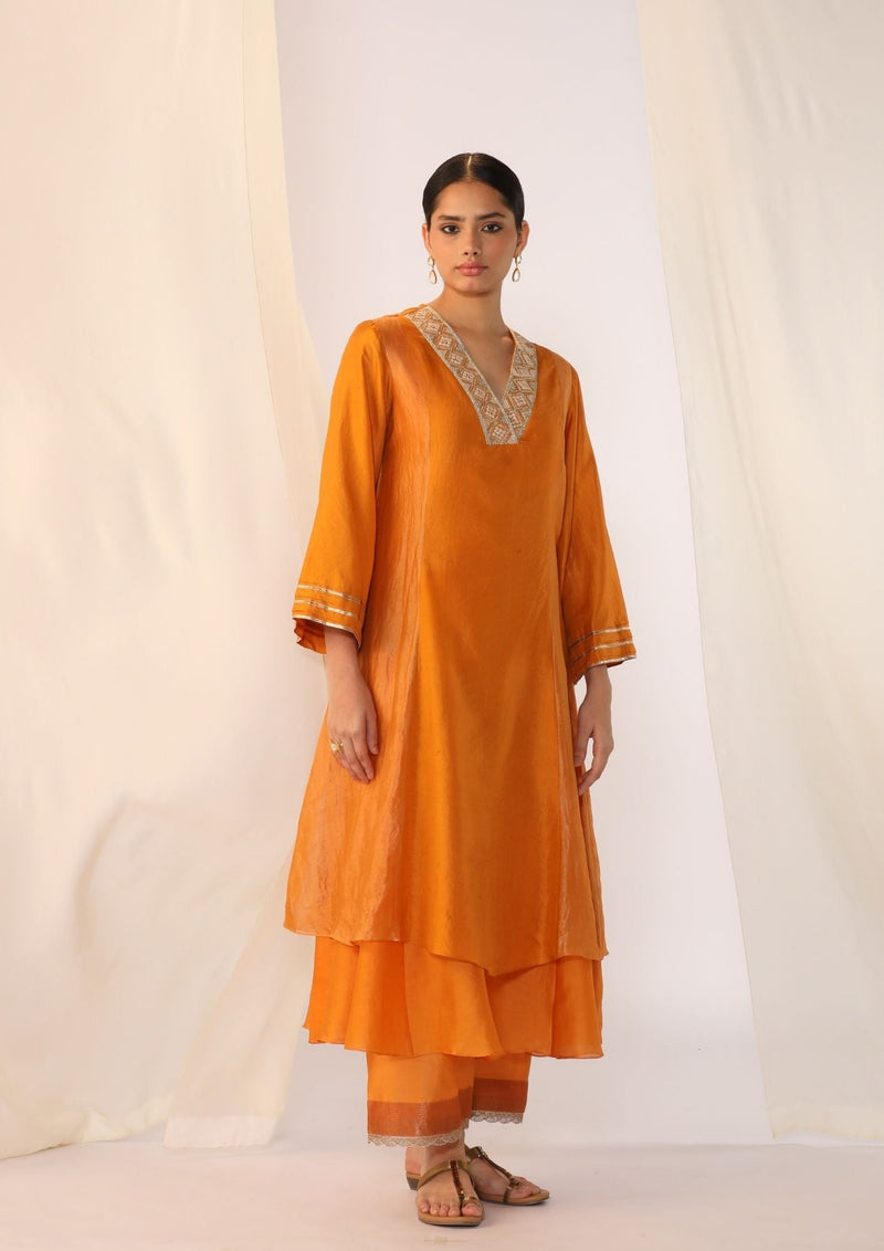 Double-layer kurta with handwork on neckline paired with pants silk by Myoho in orange color for women Worldwide