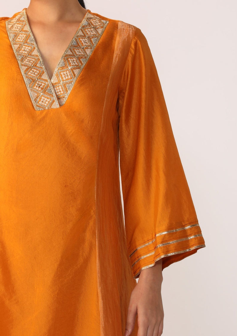 Double-layer kurta with handwork on neckline paired with pants silk by Myoho in orange color for women Worldwide