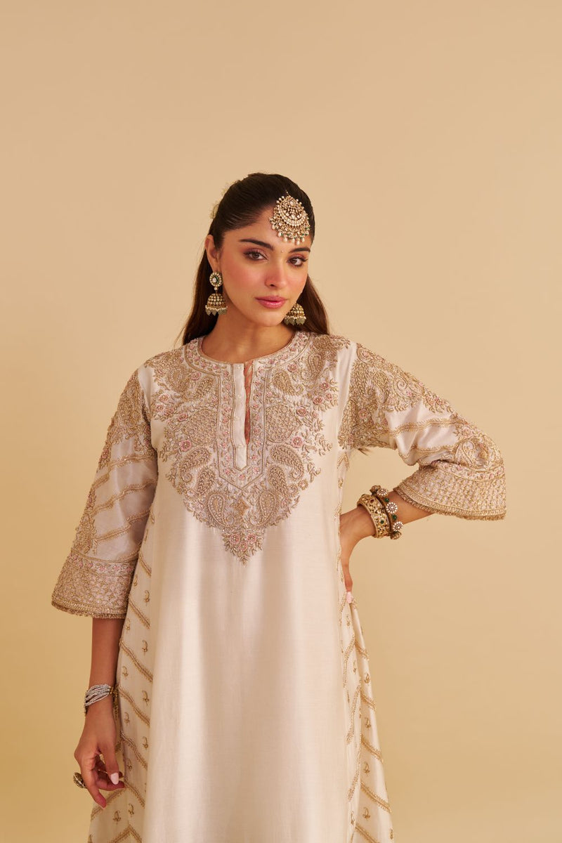 Aqsha - Dabka Zardozi Embroidered Rich Banarasi Daisy Ivory Long Chauga & Palazzo silk by SHEETAL BATRA in ivory color for women Worldwide