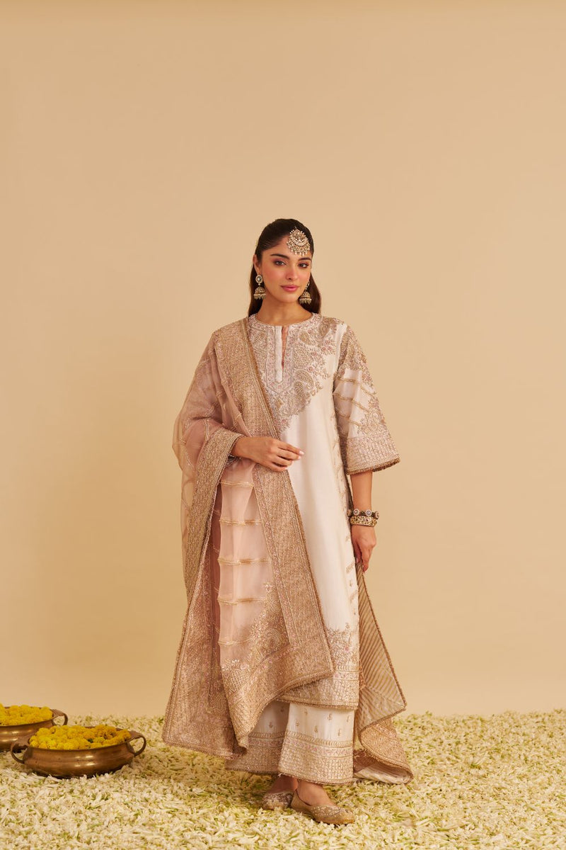 Aqsha - Dabka Zardozi Embroidered Rich Banarasi Daisy Ivory Long Chauga & Palazzo silk by SHEETAL BATRA in ivory color for women Worldwide