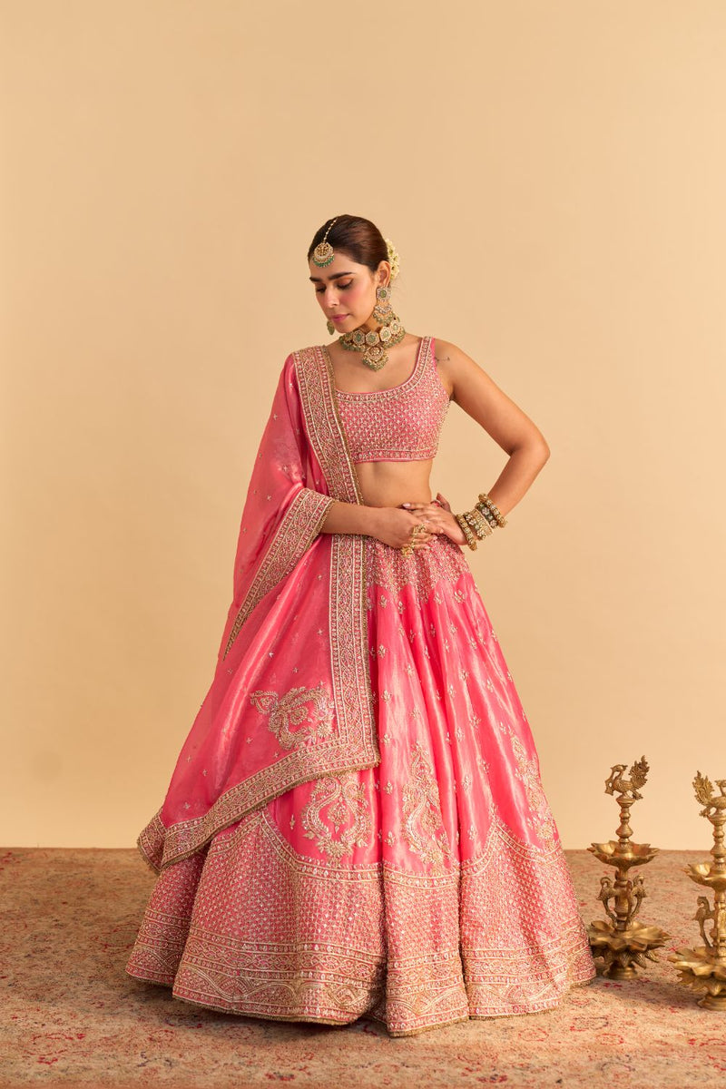 Aashina - Dabka Zardozi Embroidered Pure Tissue Carrot Pink Lehenga Set by SHEETAL BATRA in pink color for women Worldwide