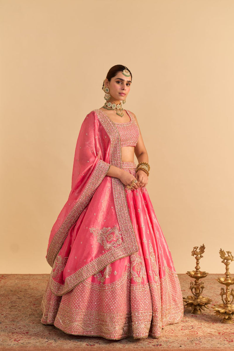 Aashina - Dabka Zardozi Embroidered Pure Tissue Carrot Pink Lehenga Set by SHEETAL BATRA in pink color for women Worldwide