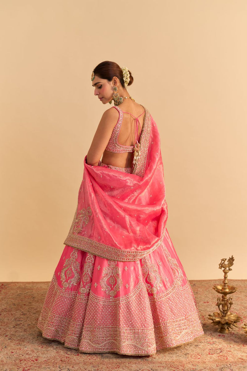 Aashina - Dabka Zardozi Embroidered Pure Tissue Carrot Pink Lehenga Set by SHEETAL BATRA in pink color for women Worldwide