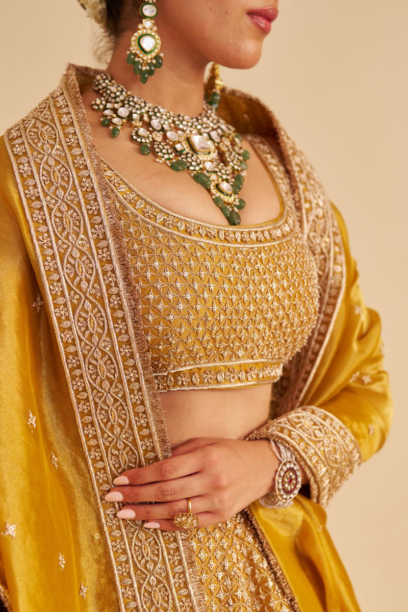 Aashina - Dabka Zardozi Embroidered Pure Tissue Mustard Lehenga Set silk by SHEETAL BATRA in gold color for women Worldwide