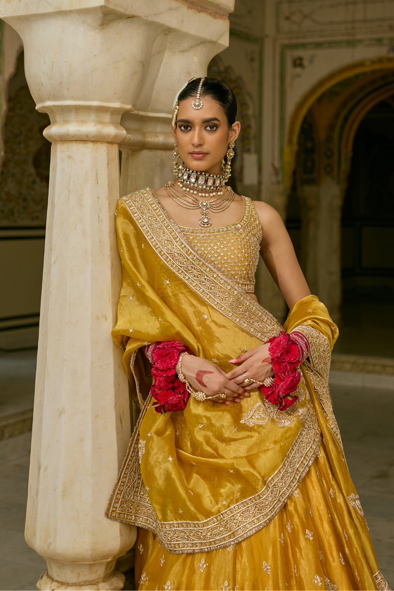 Aashina - Dabka Zardozi Embroidered Pure Tissue Mustard Lehenga Set silk by SHEETAL BATRA in gold color for women Worldwide
