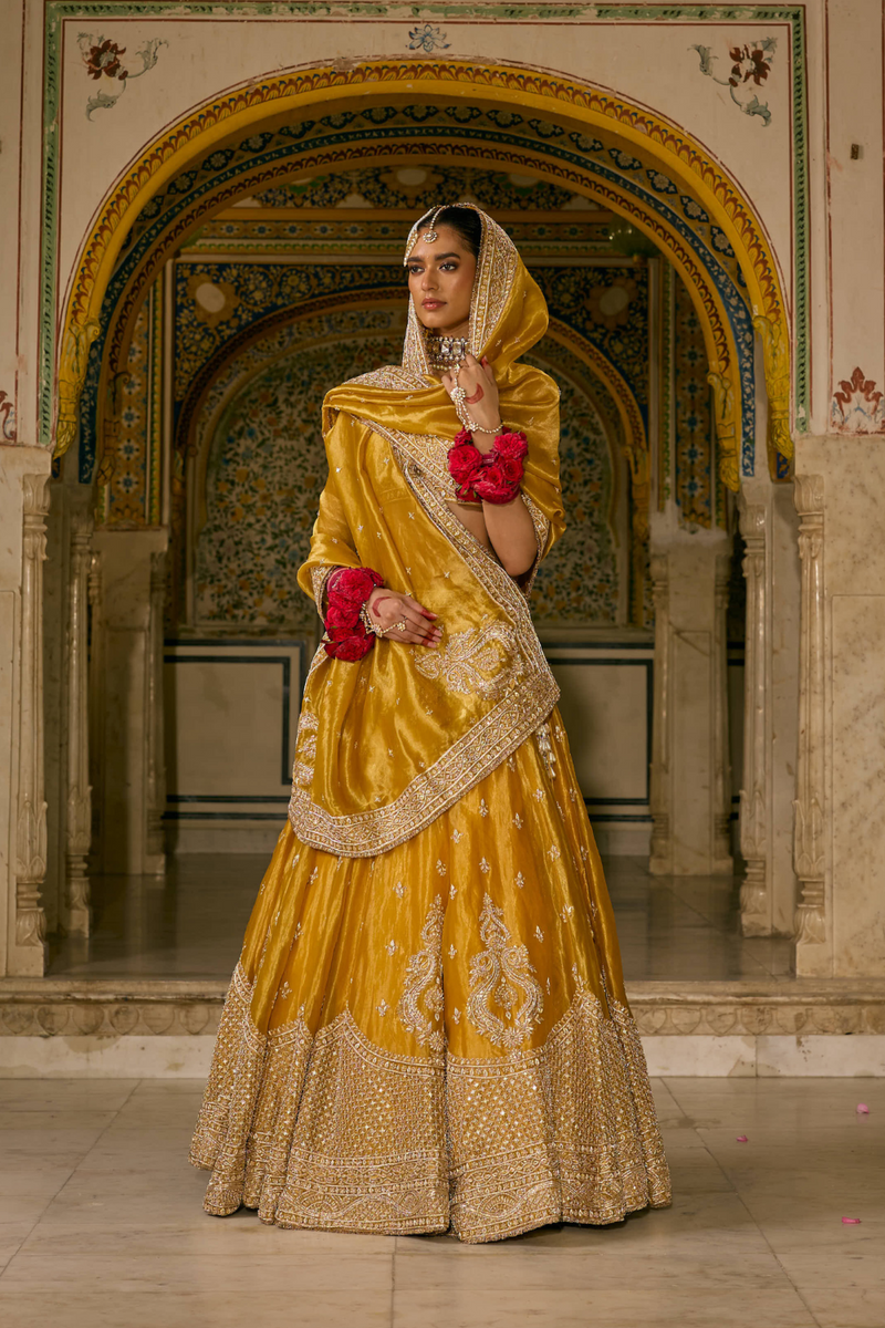 Aashina - Dabka Zardozi Embroidered Pure Tissue Mustard Lehenga Set silk by SHEETAL BATRA in gold color for women Worldwide