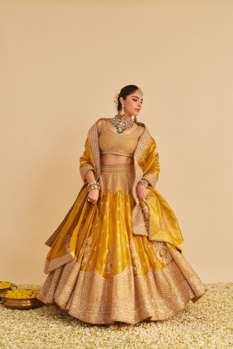 Aashina - Dabka Zardozi Embroidered Pure Tissue Mustard Lehenga Set silk by SHEETAL BATRA in gold color for women Worldwide