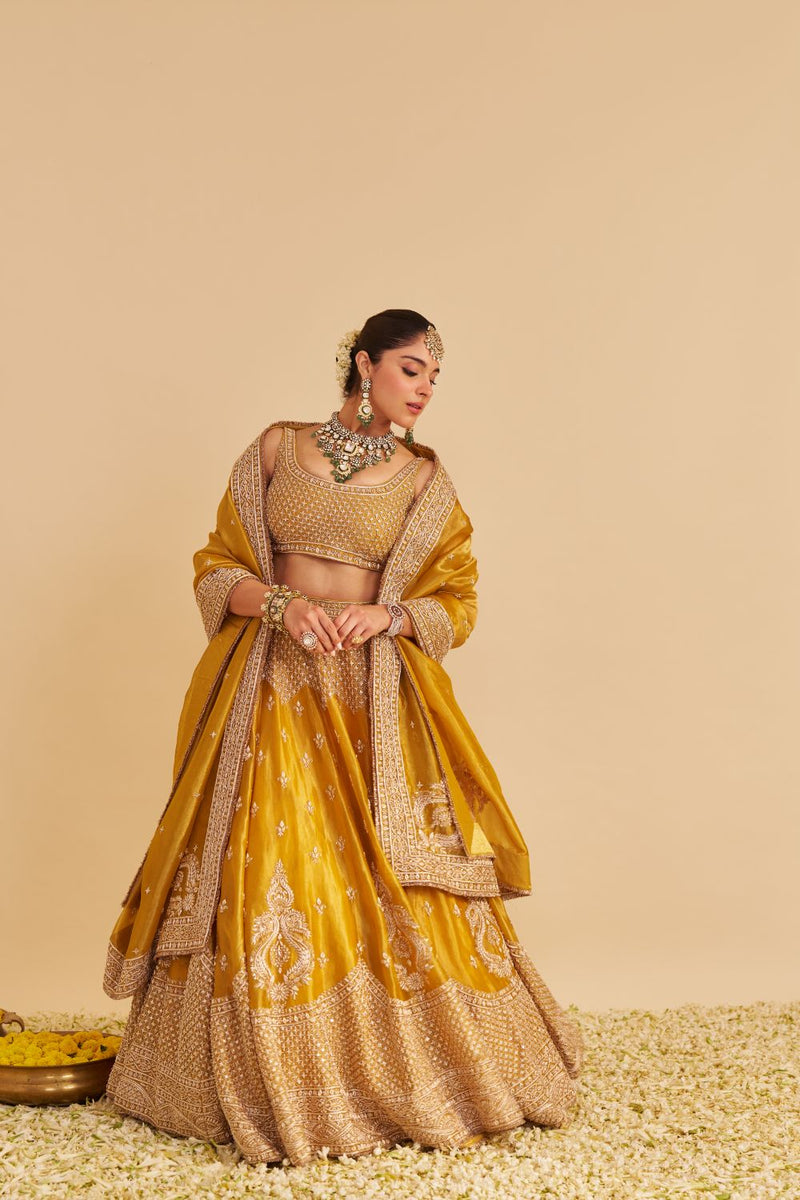 Aashina - Dabka Zardozi Embroidered Pure Tissue Mustard Lehenga Set silk by SHEETAL BATRA in gold color for women Worldwide