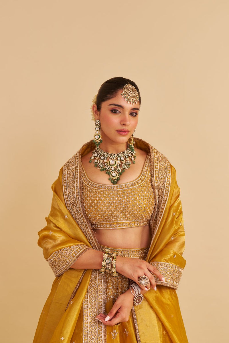 Aashina - Dabka Zardozi Embroidered Pure Tissue Mustard Lehenga Set silk by SHEETAL BATRA in gold color for women Worldwide