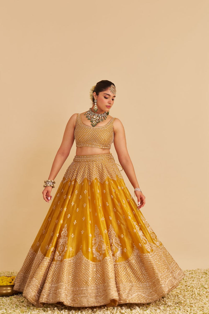 Aashina - Dabka Zardozi Embroidered Pure Tissue Mustard Lehenga Set silk by SHEETAL BATRA in gold color for women Worldwide