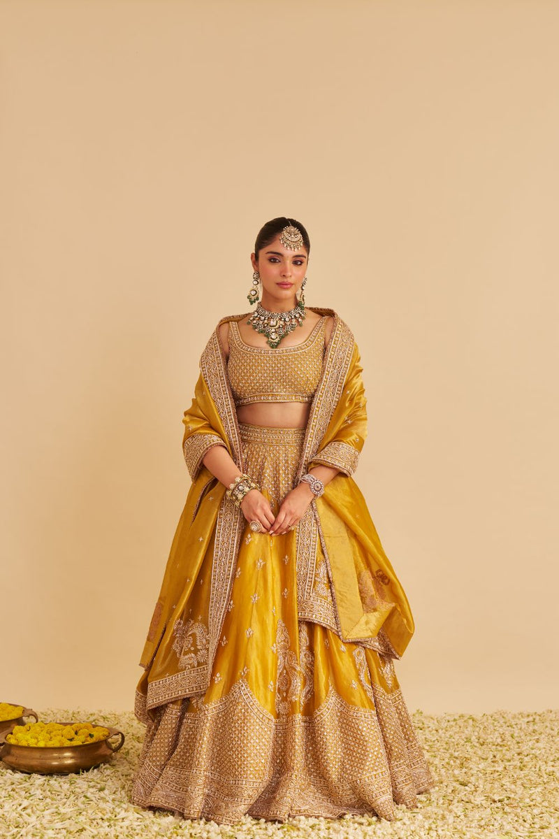 Aashina - Dabka Zardozi Embroidered Pure Tissue Mustard Lehenga Set silk by SHEETAL BATRA in gold color for women Worldwide