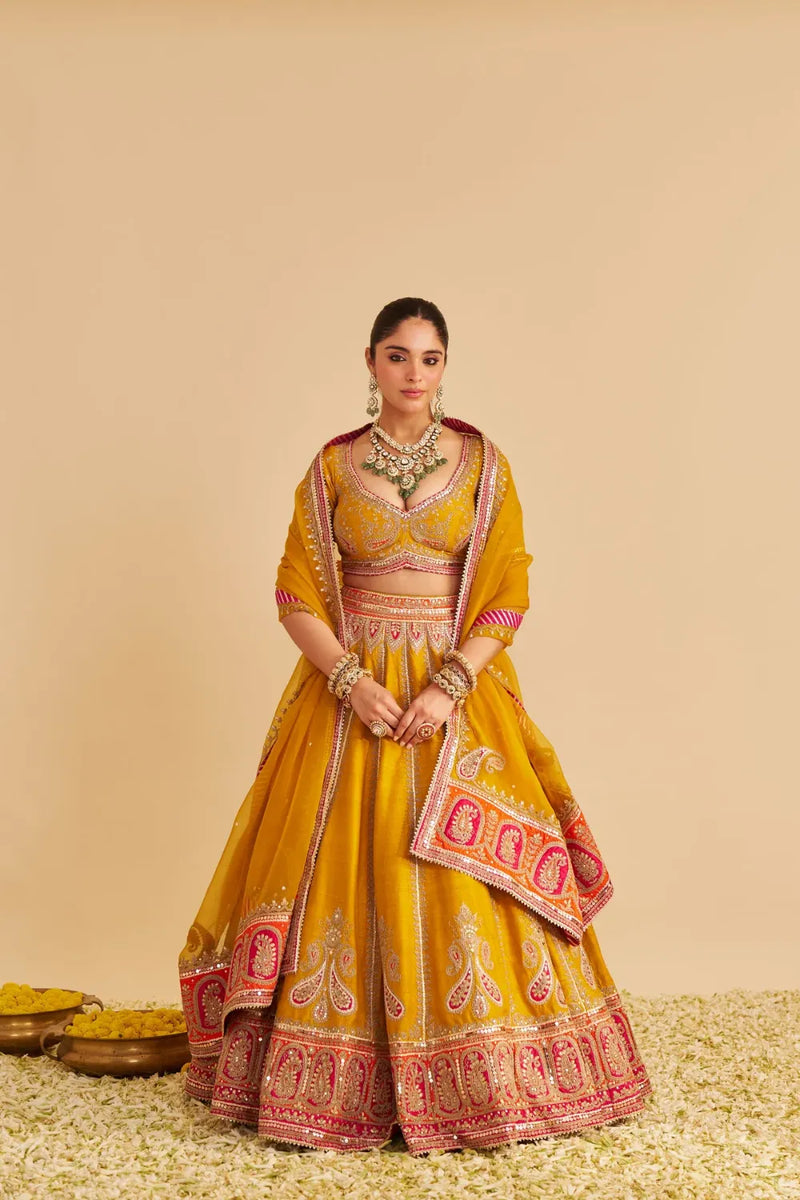 Amara - Hand Embroidered Raw Silk Mustard Bridal Lehenga Set silk by SHEETAL BATRA in mustard color for women Worldwide