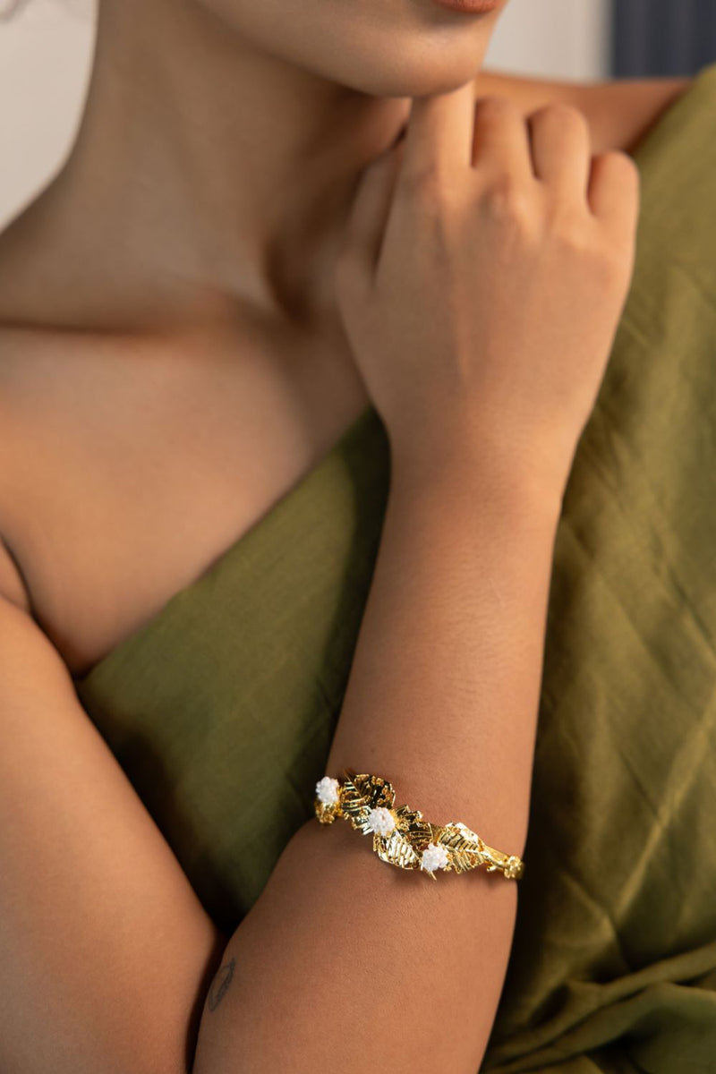 Pushpi kada 18k gold plated on brass bangle and bracelet by Aarjavee in gold for women Worldwide