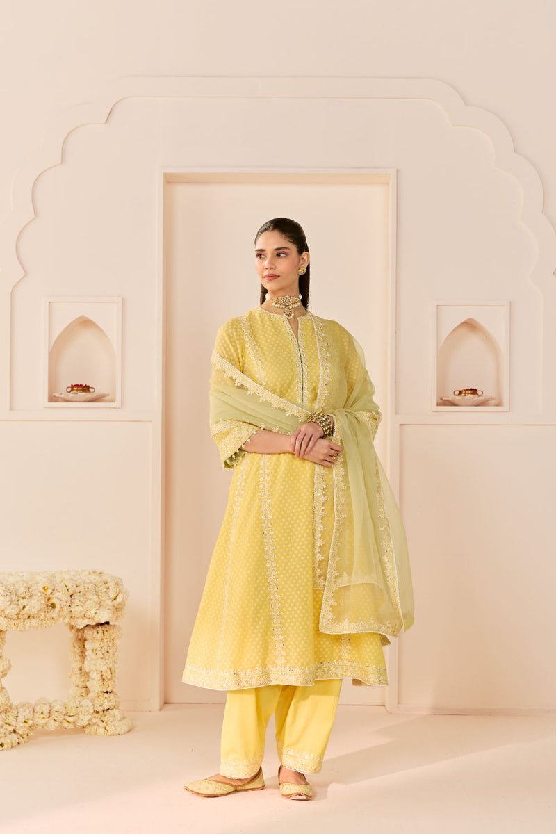 FIRDAUS -LEMON YELLOW LONG KALIDAAR CHAUGA WITH DOGRI SALWAR AND DUPATTA chanderi silk kurta/kurta set by SHEETAL BATRA in lemon yellow with mint green for women Worldwide