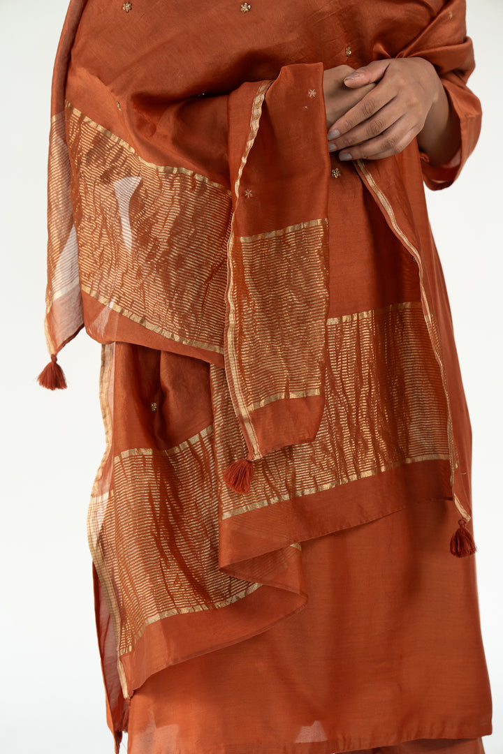Gulzar Kurta Set with 
Ayra Odhani-Rust silk by Nirjara in rust color for women Worldwide