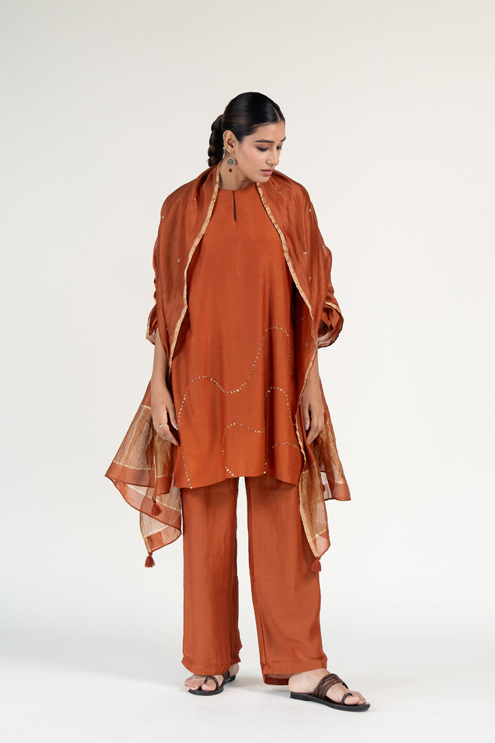 Mehr Kurta Set 
with Ayra Odhani-Rust silk by Nirjara in rust color for women Worldwide