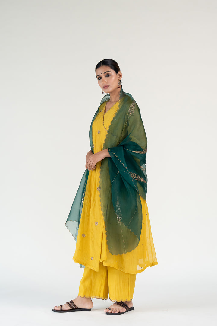 Yellow Angarkha Set
with Shama Odhani-Mustard & Emerald chanderi by Nirjara in yellow color for women Worldwide