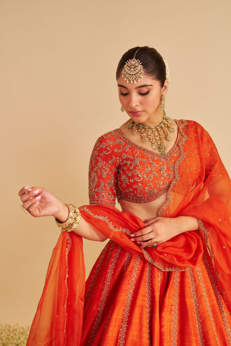 Naazila - Dabka Zardozi Embroidered Raw Silk Burnt Orange Lehenga Set silk by SHEETAL BATRA in orange color for women Worldwide
