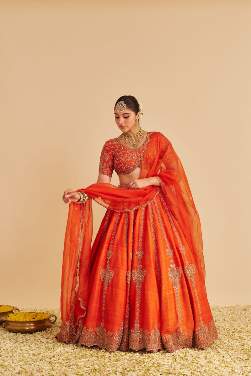 Naazila - Dabka Zardozi Embroidered Raw Silk Burnt Orange Lehenga Set silk by SHEETAL BATRA in orange color for women Worldwide