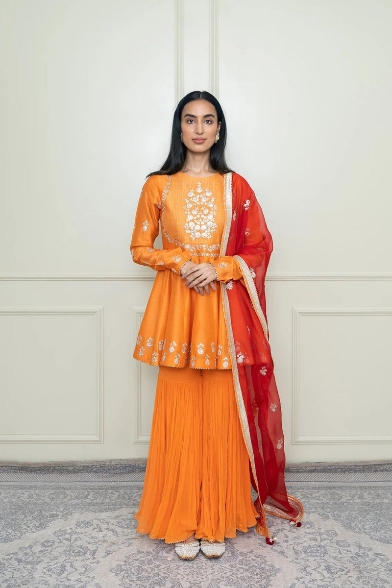 Shahana Peplum kurta with garara and dupatta-Pumpkin orange & scarlet red silk by SHEETAL BATRA in orange color for women Worldwide