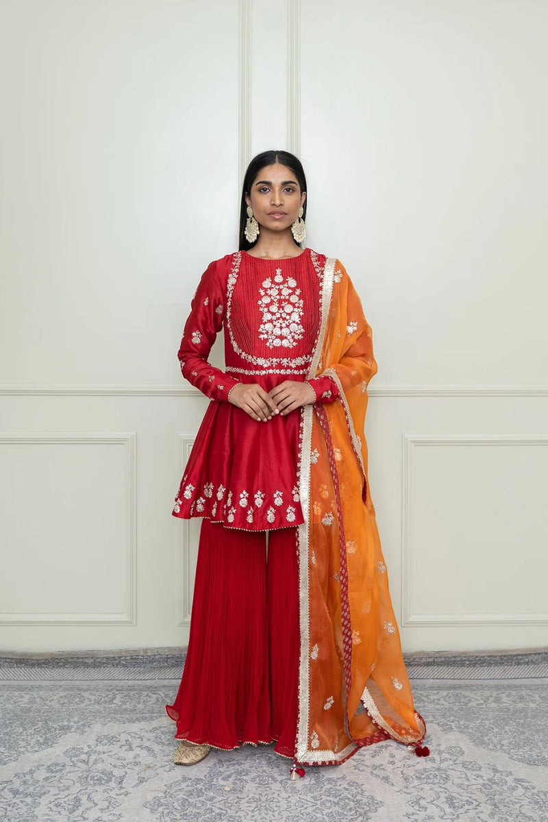 Shahana Peplum kurta with garara and dupatta-Scarlet red & pumpkin orange silk by SHEETAL BATRA in red color for women Worldwide