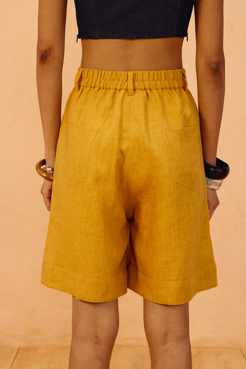 The Golden Linen Shorts 100% linen short by SUI in mustard for women Worldwide