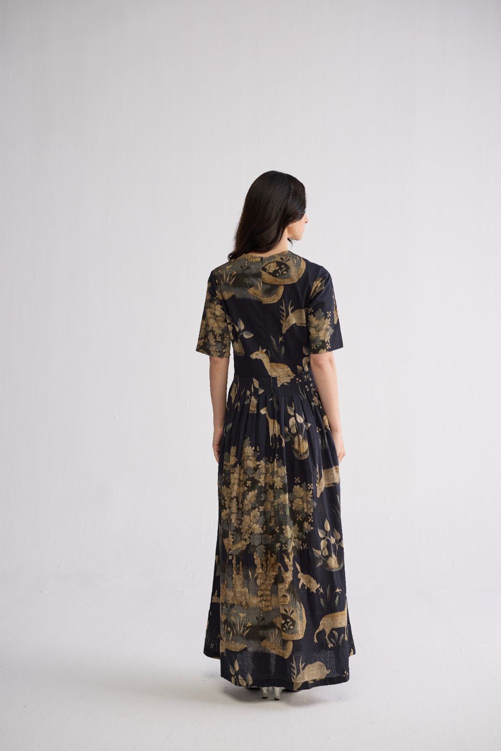half pleated dress Avril gown, A box pleated dress features a type of pleating where fabric is folded into square-shaped pleats, giving the dress a structured and voluminous look. , A half-shoulder gown, also known as